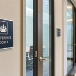 Modern ADA-compliant tactile braille room identification signs installed inside a commercial office building in Montgomery County, Maryland.