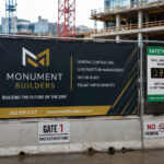 Construction site signage at a DC Metro project featuring safety notices, PPE requirements, entrance signs, visitor instructions, and contractor branding.