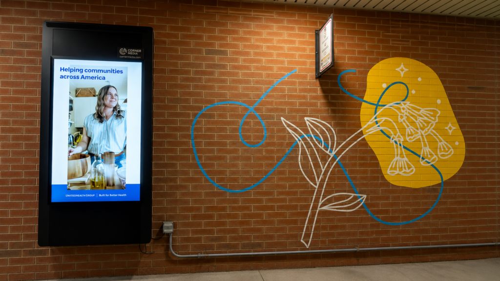 Wall-mounted digital message board installed on a brick wall at a commercial property in the DC, Maryland, and Northern Virginia region.